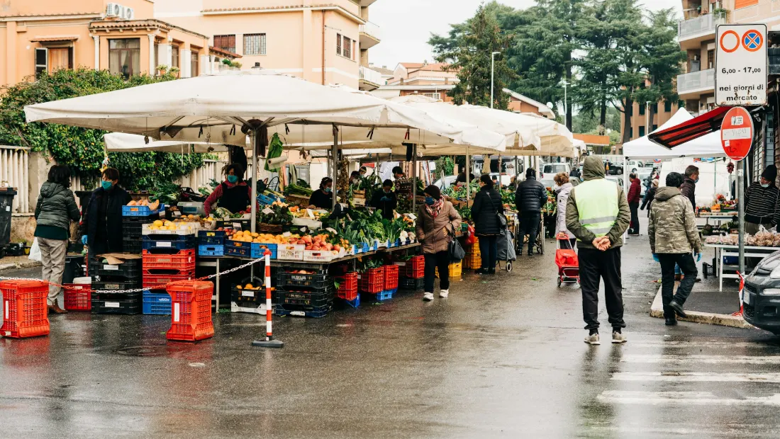 People walking through a busy local street market