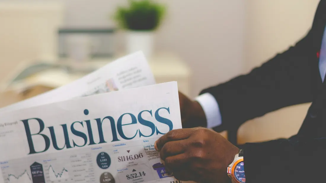 Business professional reading a business newspaper