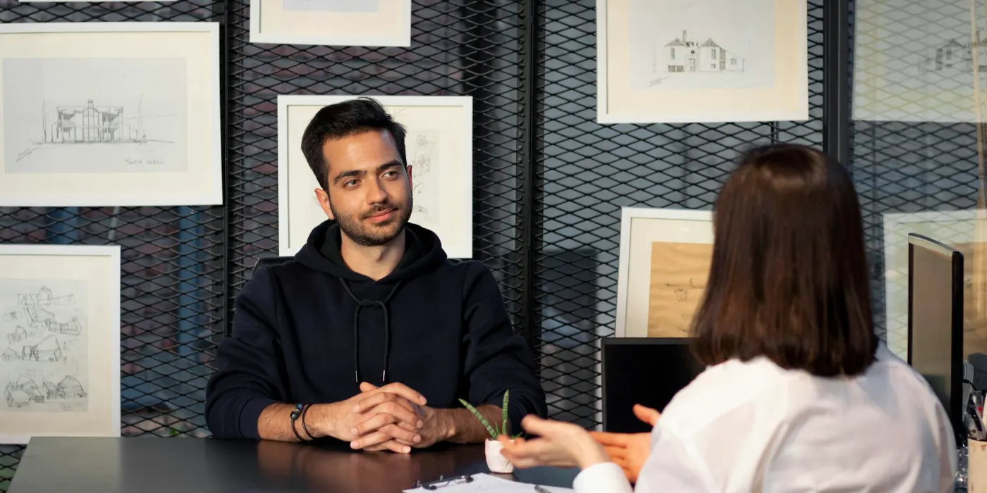 Man and woman discussing findings across a table